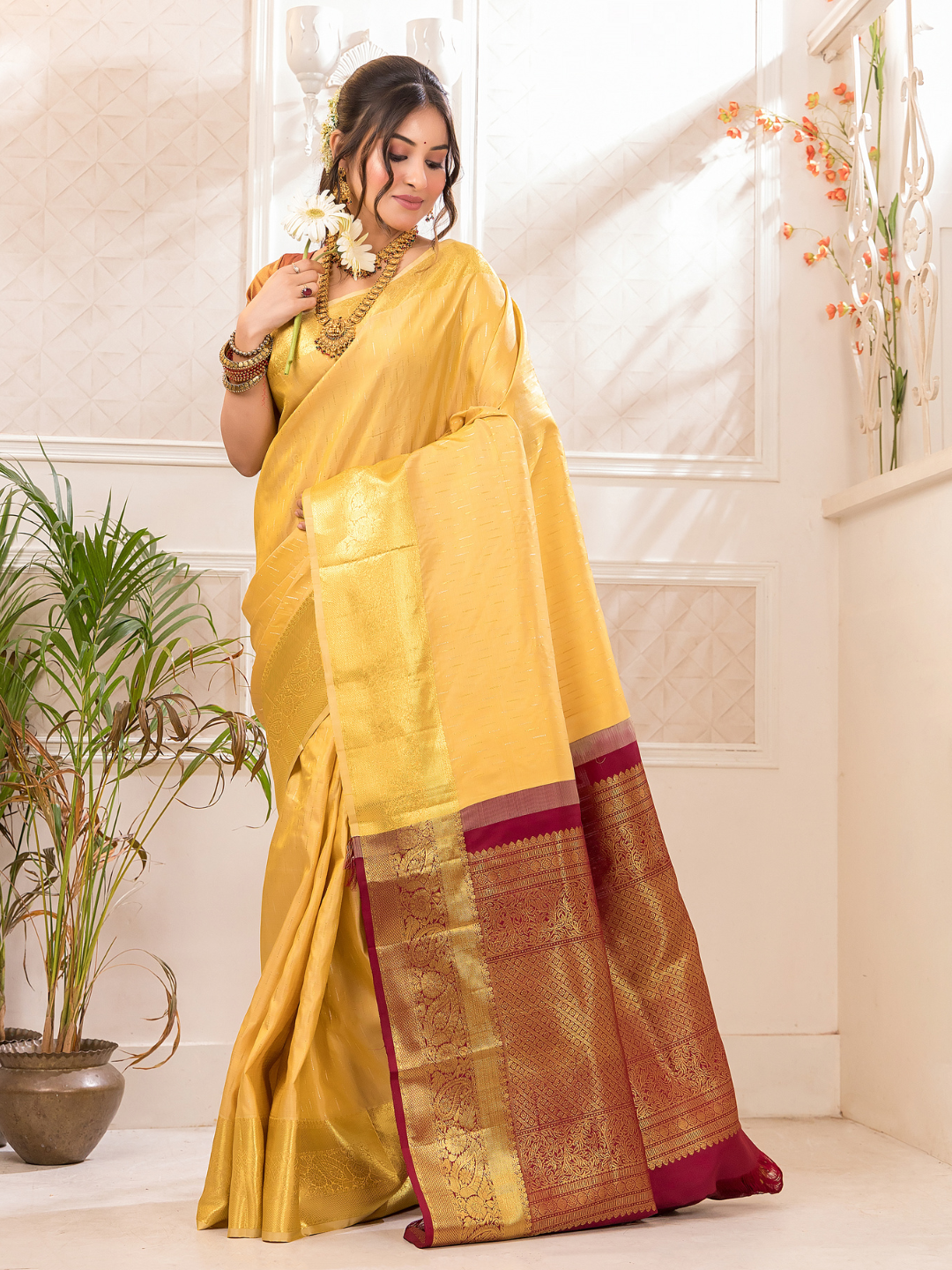 Swarna  -  Ivory silk with golden floral vine and temple border
