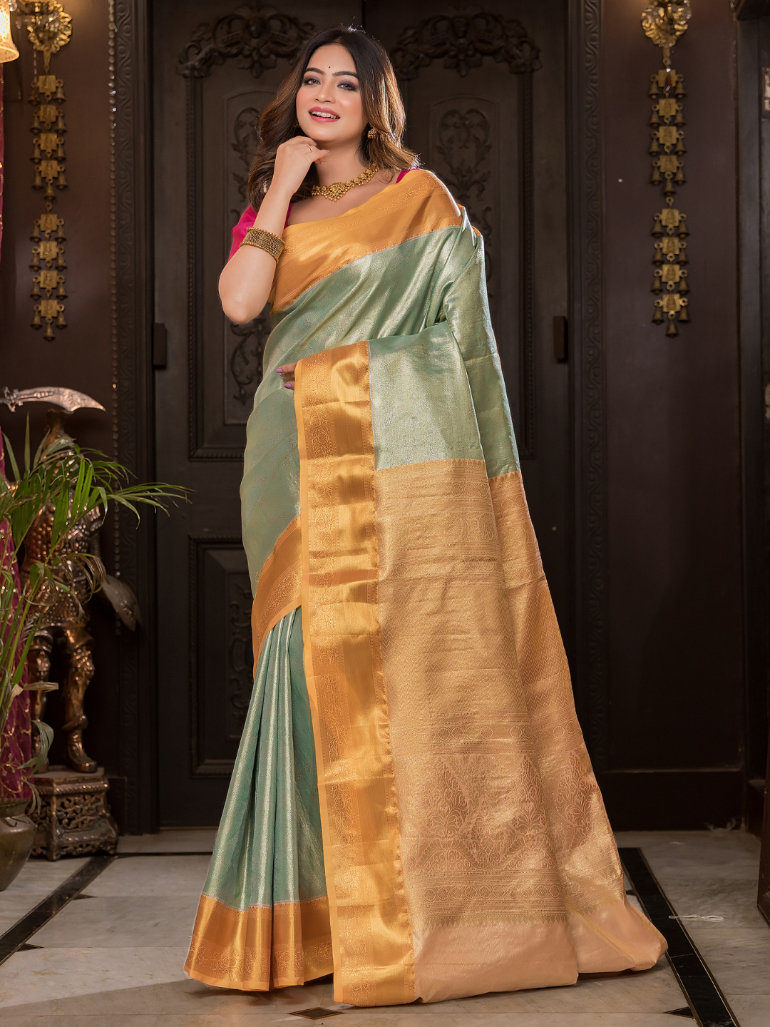 Manjusha  -  Teal green silk with golden temple pallu